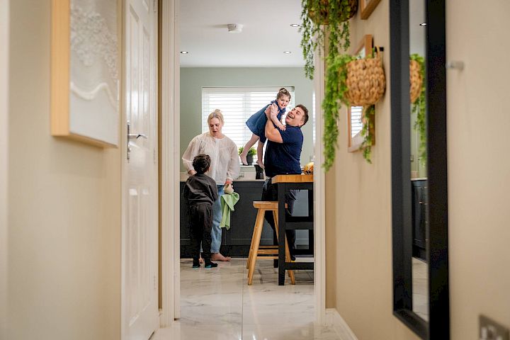 Family laughing together in home