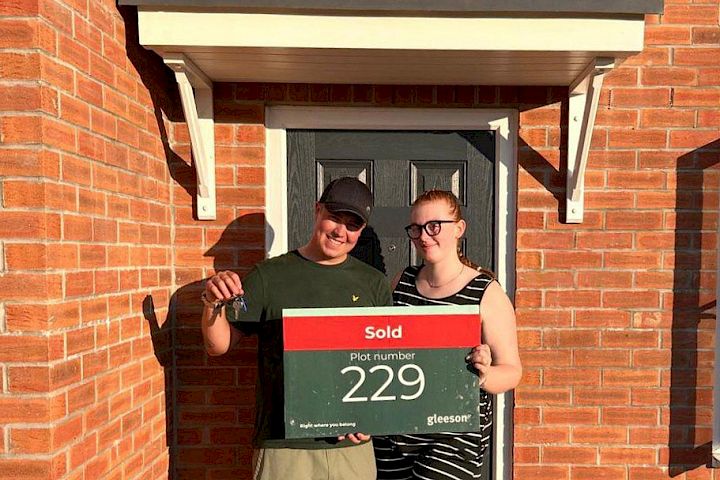 first-time buyers in front of home