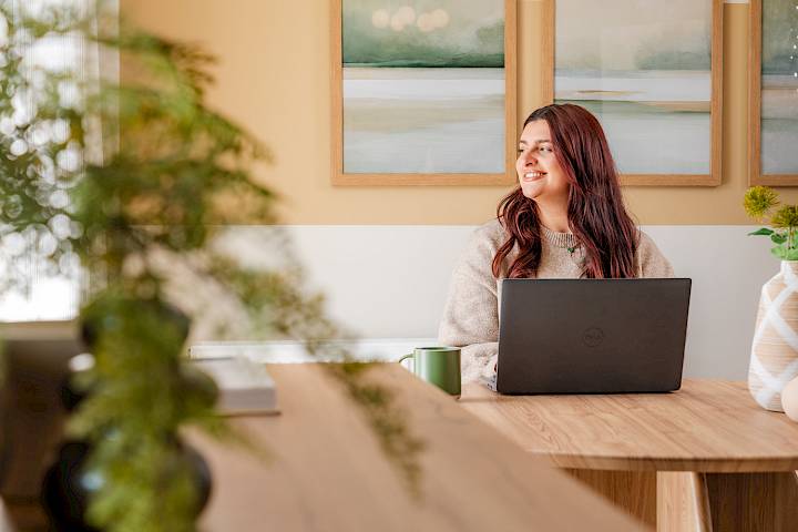 Young female sitting at the table in a kitchen