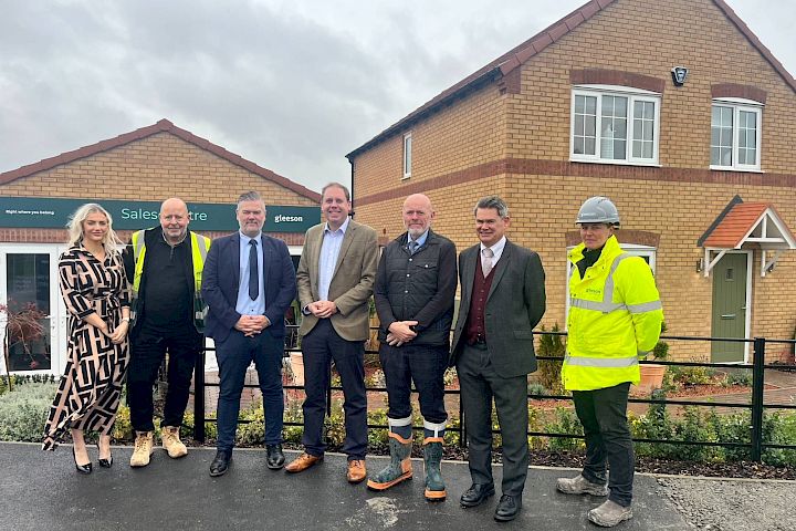 Colleagues and Charlie Dewhurst MP standing outside of a Gleeson sales centre