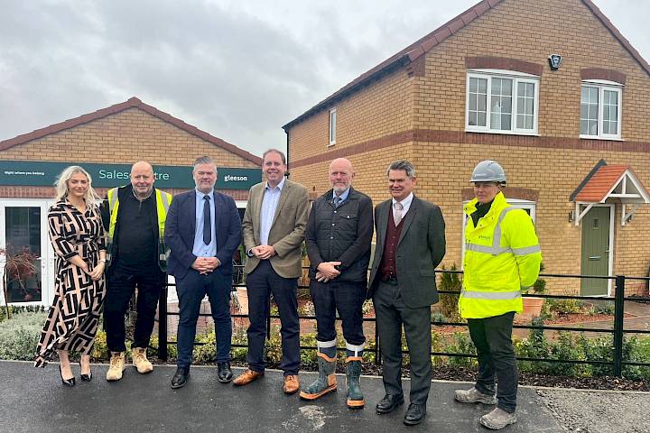 Colleagues and Charlie Dewhurst MP standing outside of a Gleeson sales centre