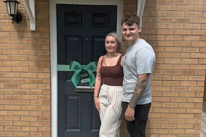 Couple stood outside their house