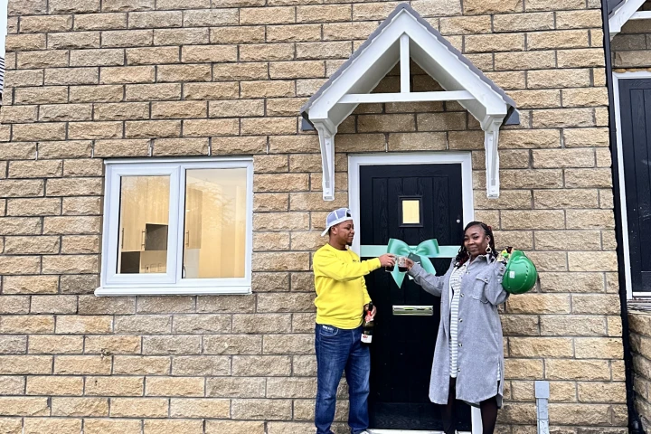 Couple in front of house